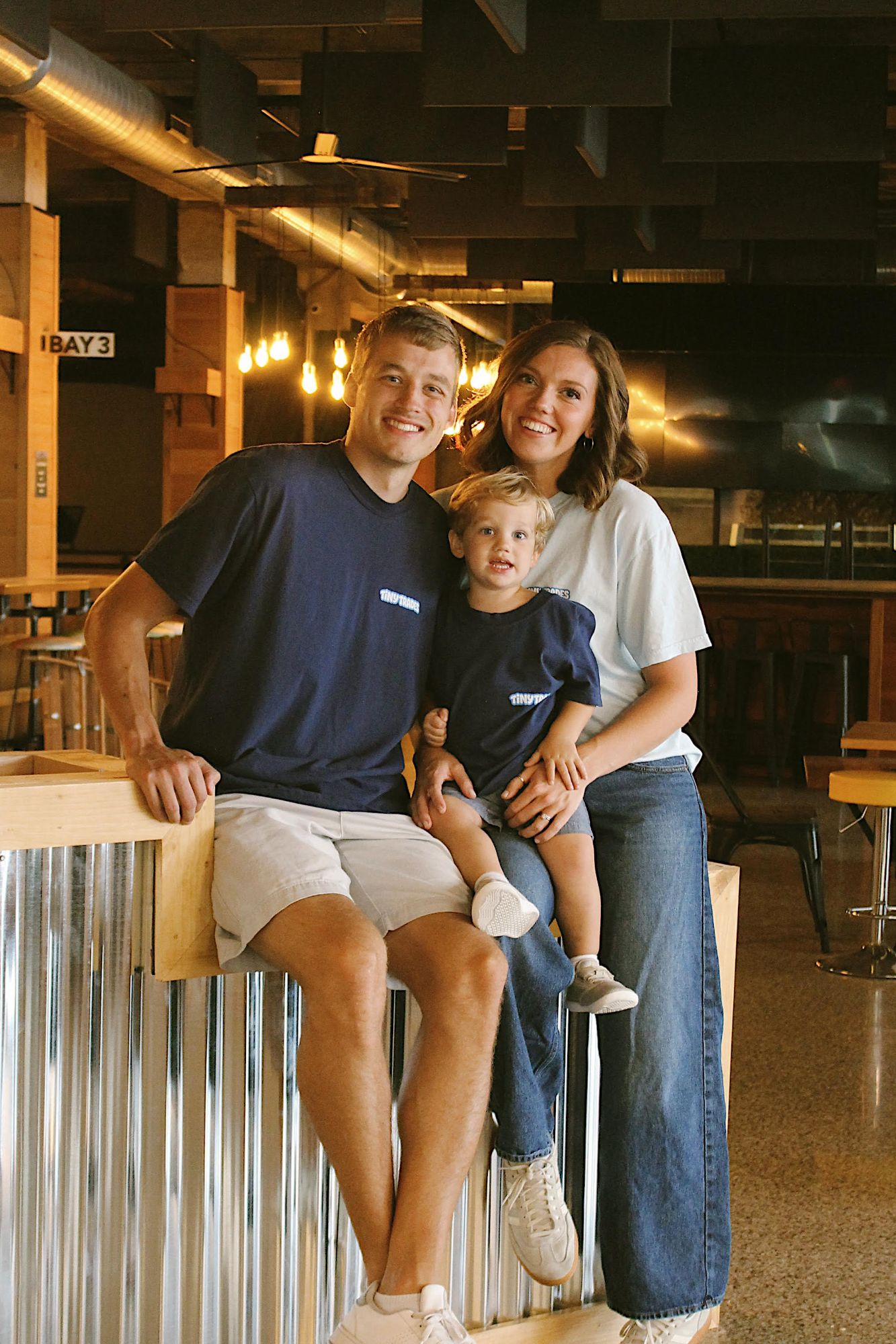 Carter and Stella Anderson with their son inside Tiny Trades in Muncie